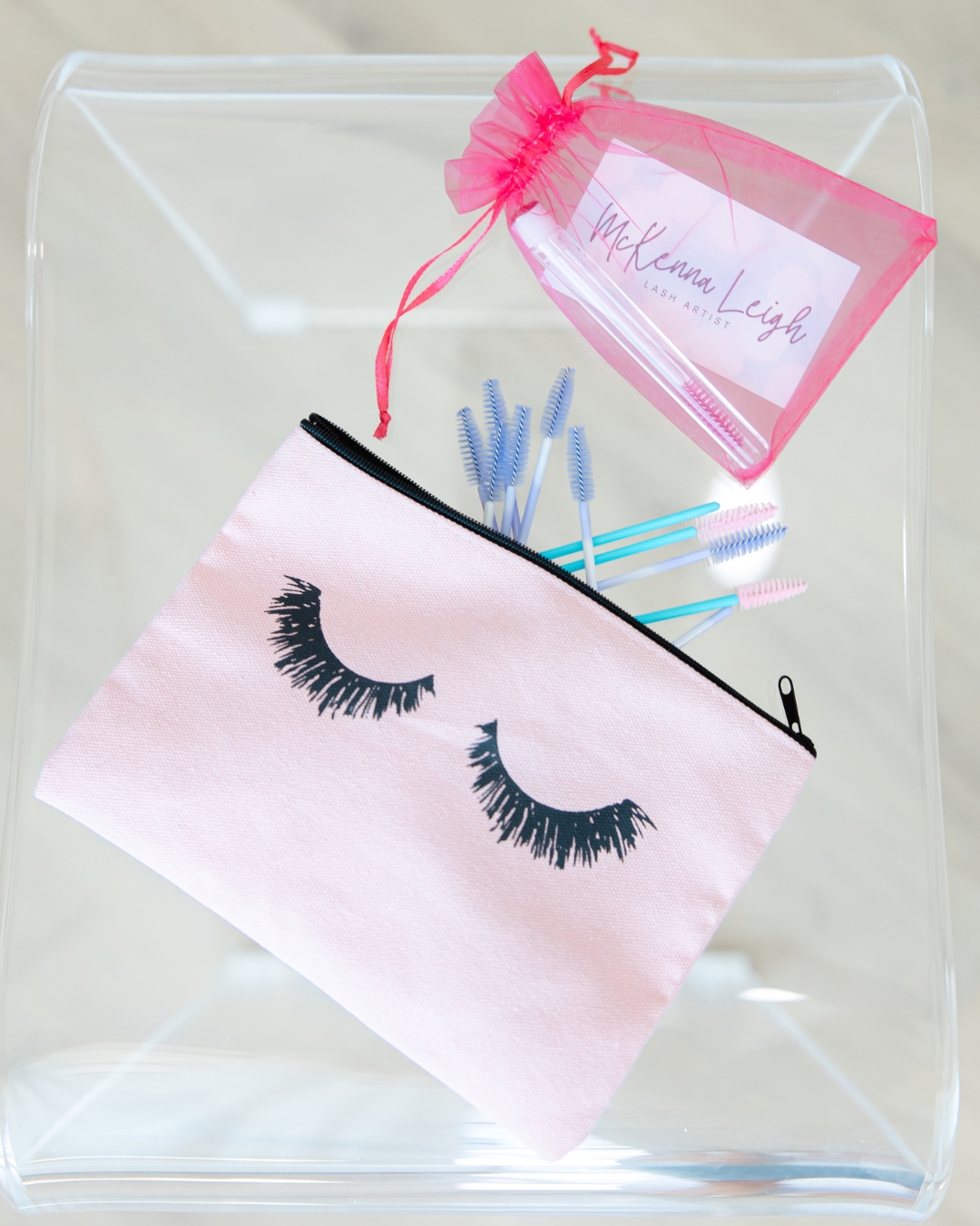 Lash brushes and a pink lash accessory pouch